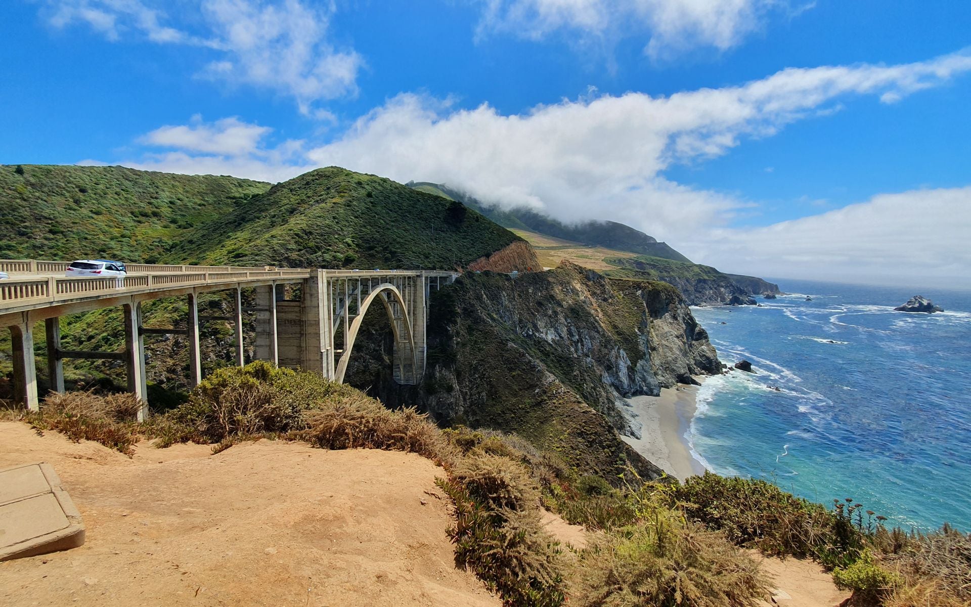 Bixby Creek Bridge on Highway 1 in Big Sur, the arched span crossing a deep coastal canyon with the Pacific beyond.