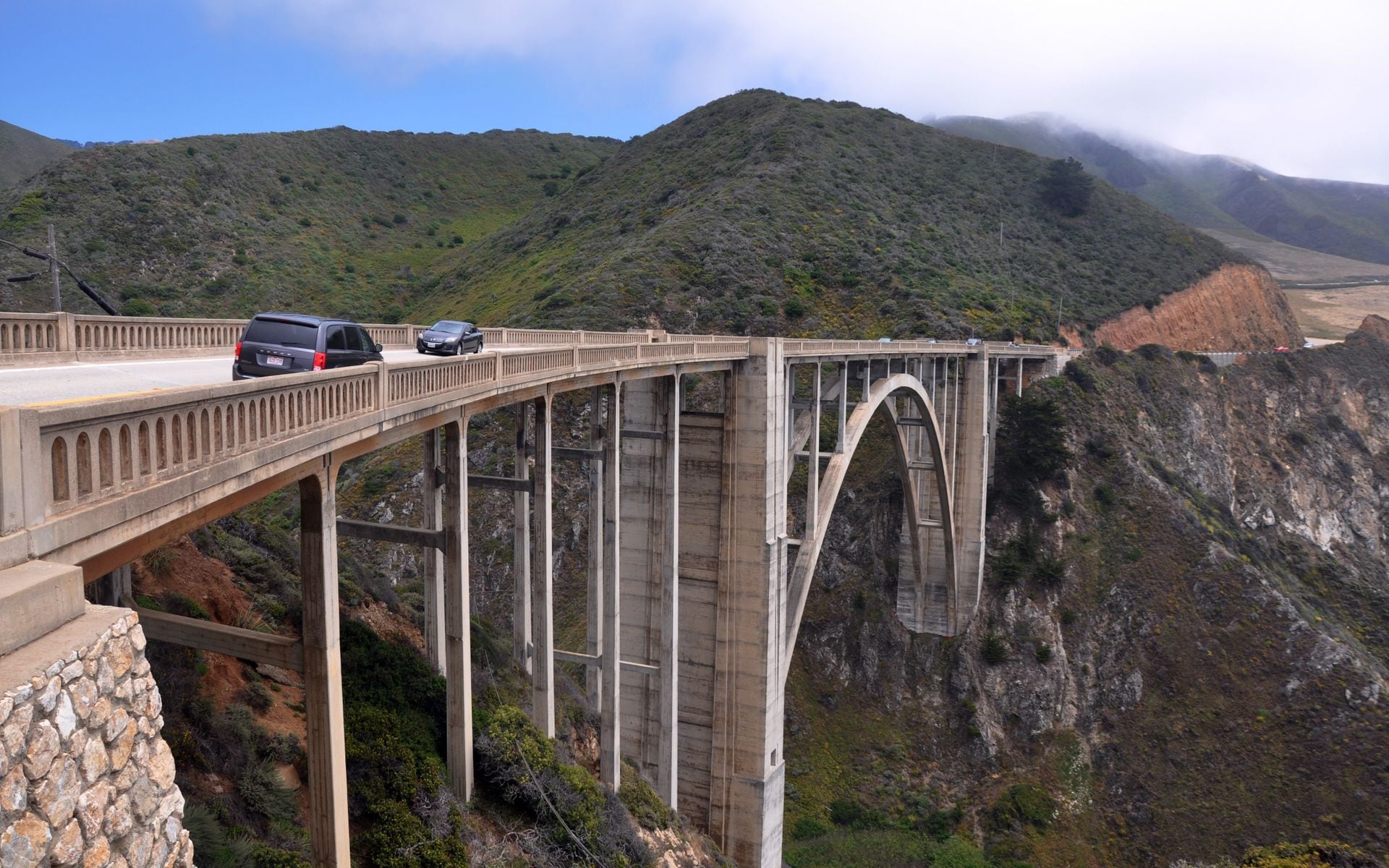The Bixby Creek Bridge arching over a coastal canyon on Highway 1 in Big Sur with the Pacific behind it