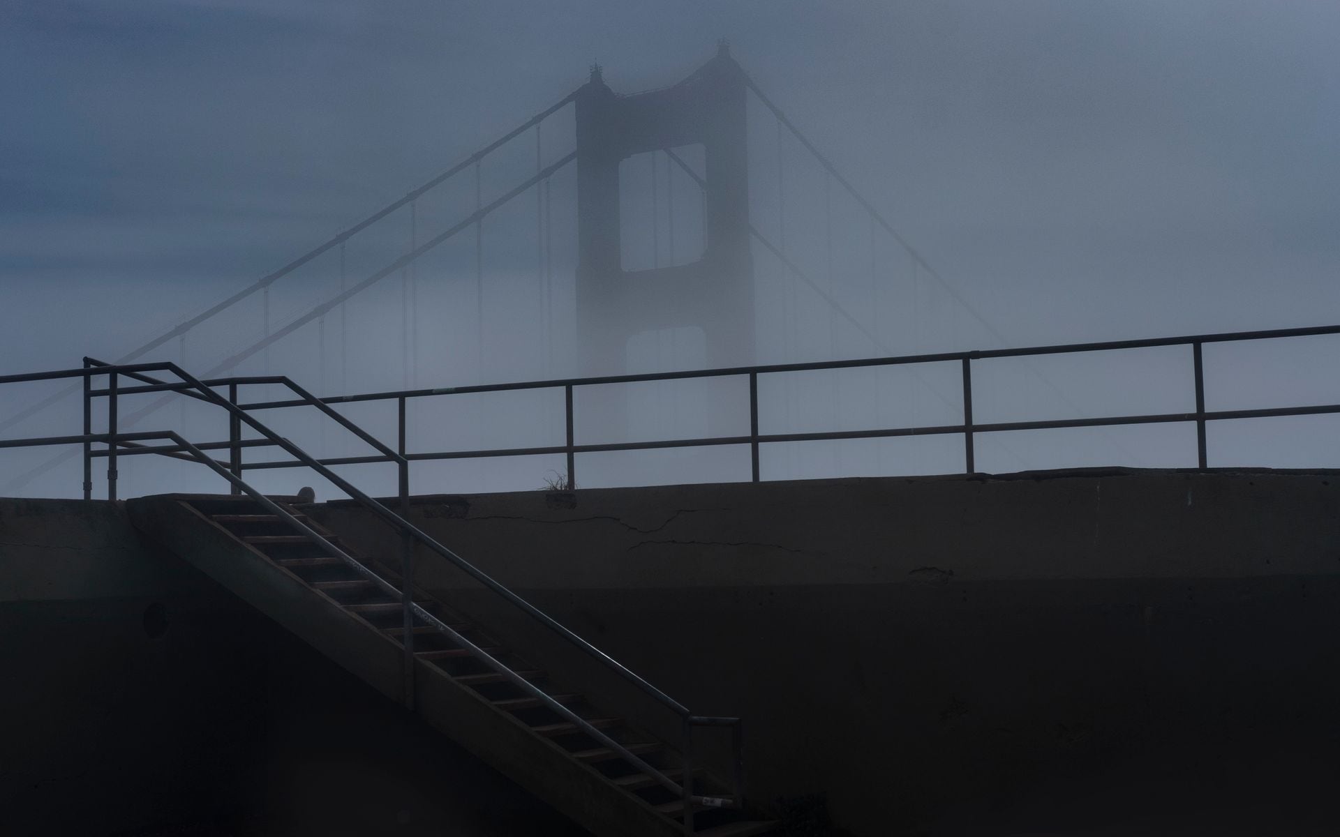 Split scene of foggy Golden Gate Bridge in the north and a sunny palm-lined Southern California beach